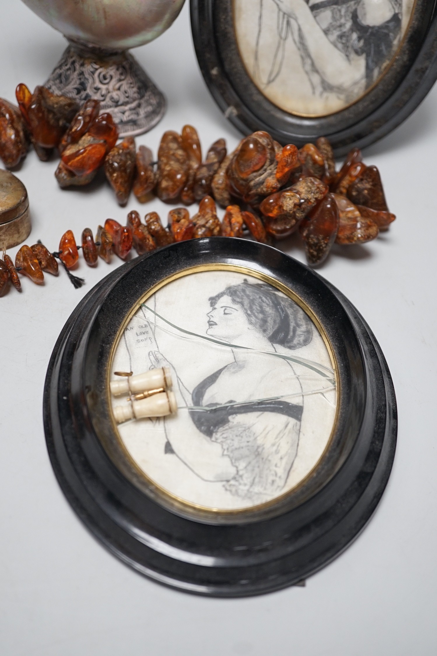 A pair of mother of pearl and silvered swan ornaments, amber and mixed collectables
